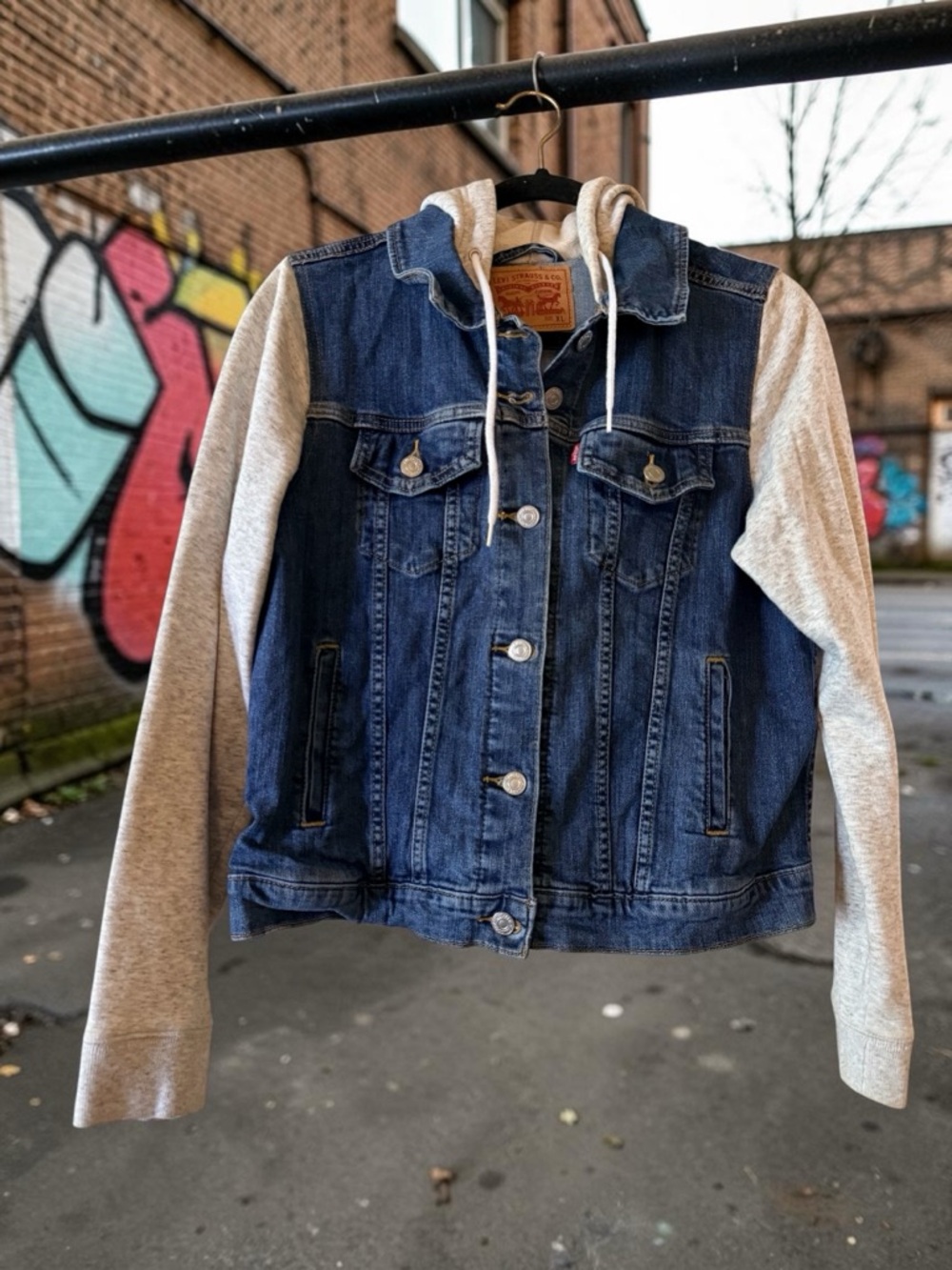 Levi's-Inspired Blue Denim Jacket with Gray Hoodie Sleeves